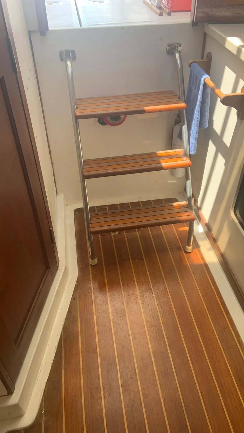 Slide: The Image of 1987 Luhrs Alura 30 interior with wooden steps and flooring. - 18