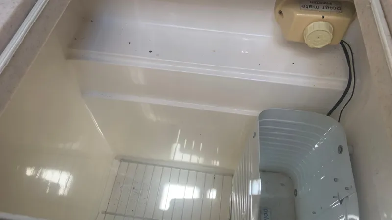 Slide: The Image of Empty refrigerator interior on a 1987 Luhrs Alura 30 boat. - 20