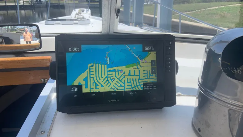 Slide: The Image of 1987 Luhrs Alura 30 boat with Garmin navigation display showing a detailed map. - 23