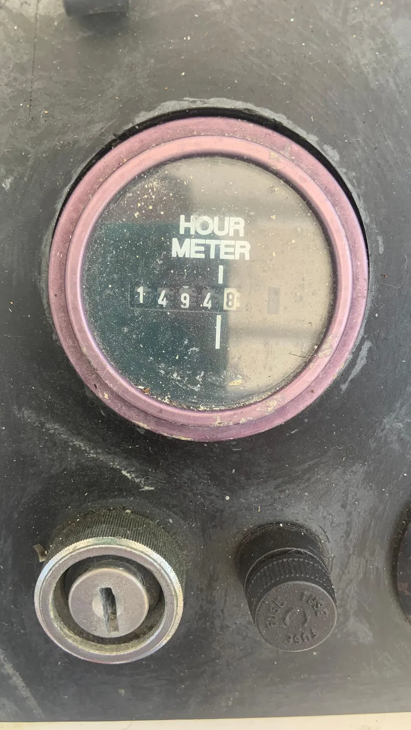 Slide: The Image of Hour meter reading 1494 on 1987 Luhrs Alura 30 boat dashboard. - 24