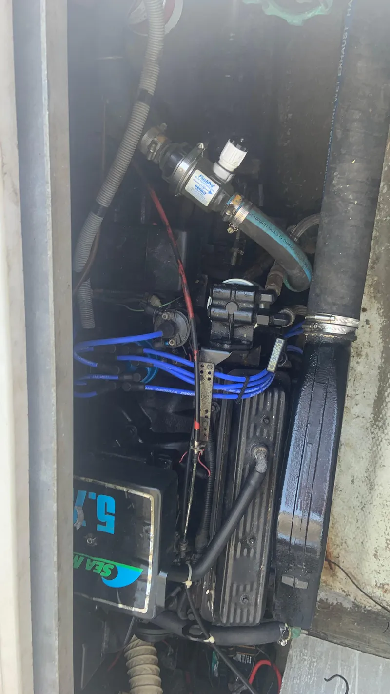 Slide: The Image of Engine compartment of a 1987 Luhrs Alura 30 boat, showing mechanical components and wiring. - 25