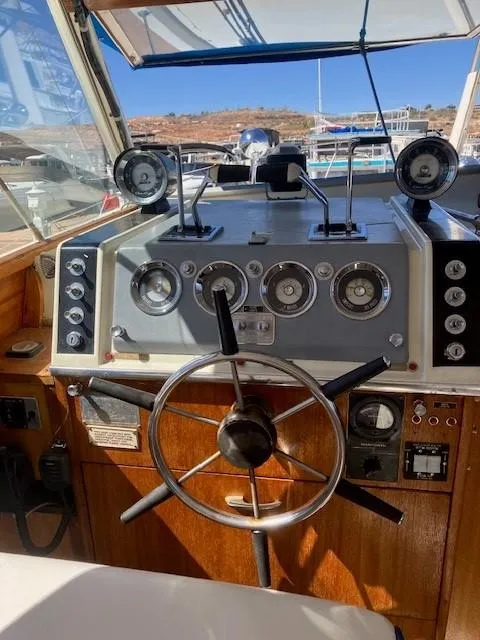 Slide: The Image of 1969 Chris-Craft Commander boat dashboard with steering wheel and gauges. - 6