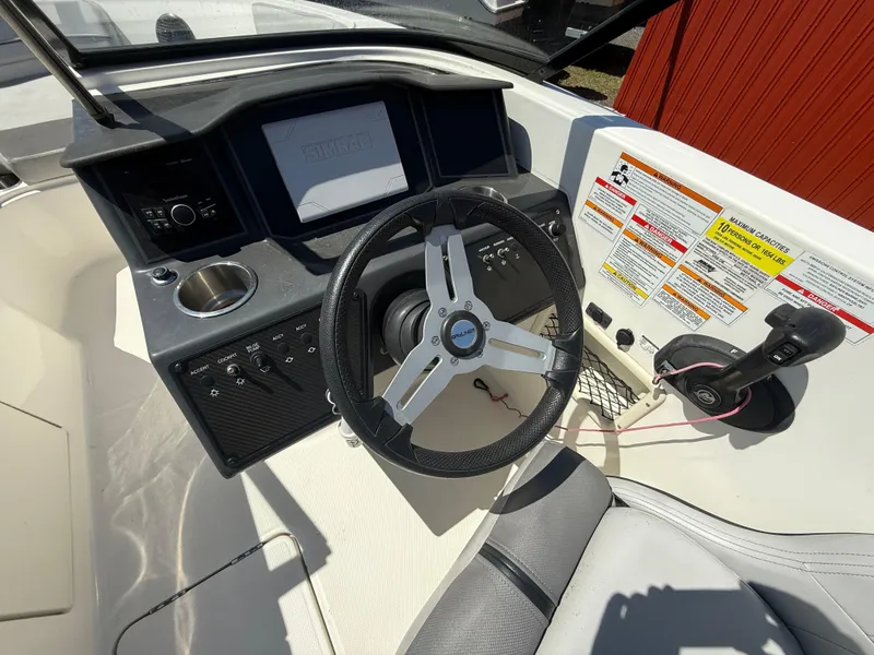 Slide: The Image of 2022 Bayliner VR6 Bowrider OB dashboard with steering wheel and control panel. - 11