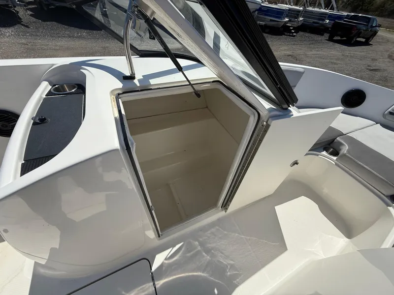 Slide: The Image of 2022 Bayliner VR6 Bowrider OB storage compartment with open hatch, showcasing interior space. - 13