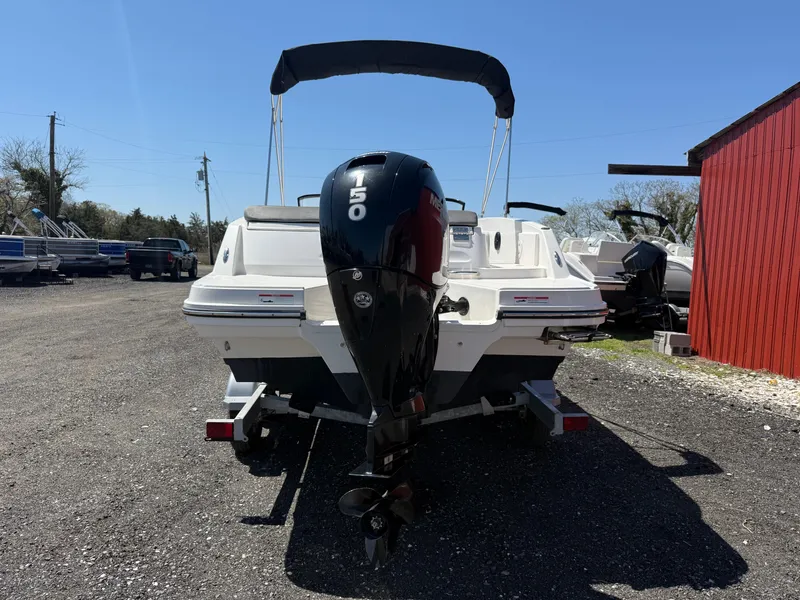 Slide: The Image of 2022 Bayliner VR6 Bowrider OB with 150 HP engine, parked outdoors. - 4