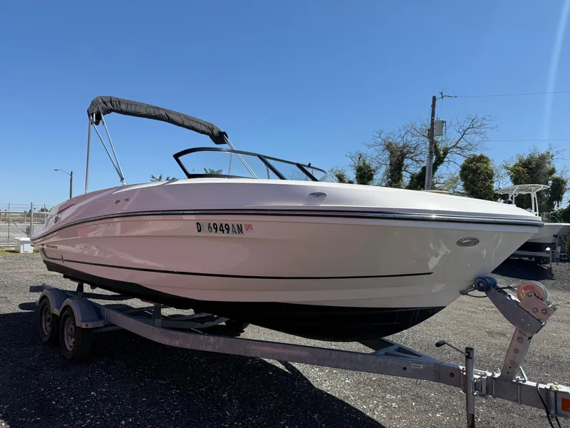 Slide: The Image of 2022 Bayliner VR6 Bowrider OB on trailer, sunny day, outdoor setting. - 7