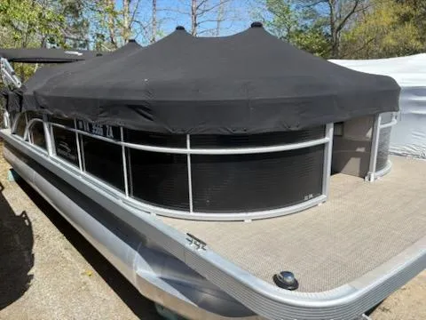Slide: The Image of 2019 Bennington 22SLX pontoon boat with black cover, parked outdoors. - 1