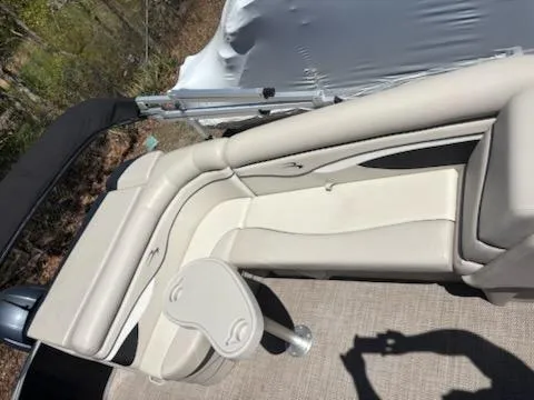 Slide: The Image of 2019 Bennington 22SLX boat interior with beige seating and small table. - 10