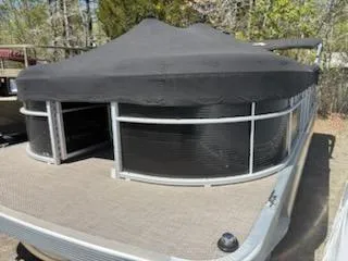 Slide: The Image of 2019 Bennington 22SLX pontoon boat with black cover, docked outdoors. - 4