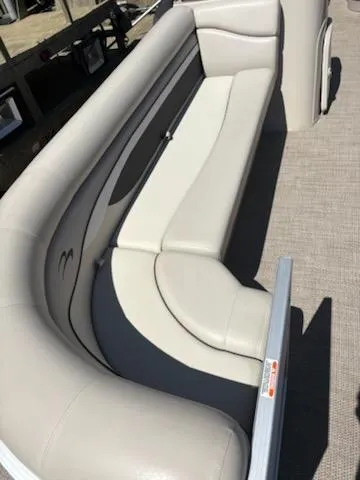 Slide: The Image of 2019 Bennington 22SLX boat interior with beige seating and carpeted flooring. - 6