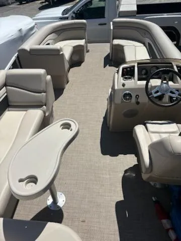 Slide: The Image of 2019 Bennington 22SLX pontoon boat interior with beige seating and steering console. - 8