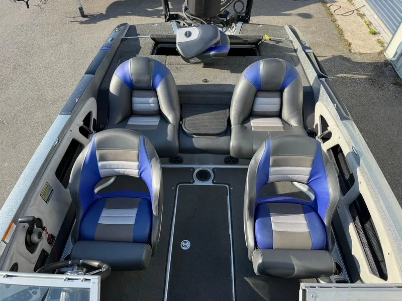 Slide: The Image of 2017 Ranger 212LS Reatta boat interior with four seats, blue and gray upholstery. - 7
