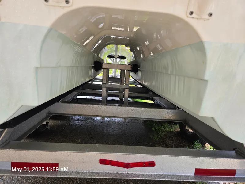 Slide: The Image of 2021 World Cat 280 DC-X boat on trailer under clear blue sky. - 1