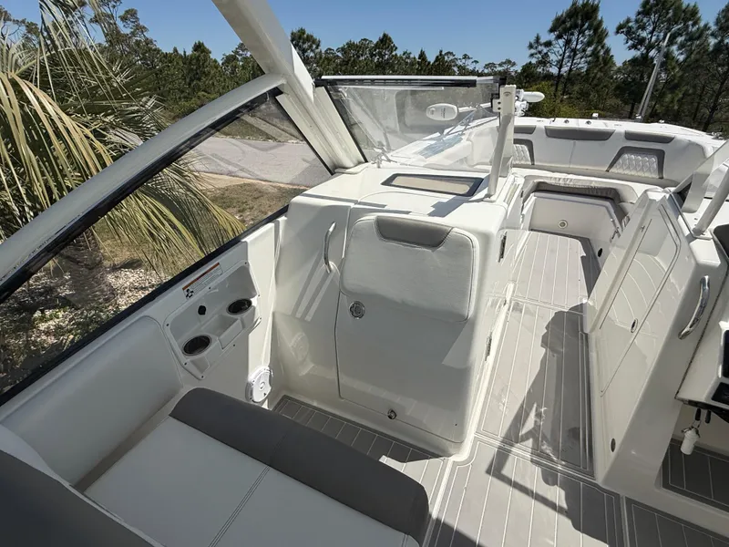 Slide: The Image of 2021 World Cat 280 DC-X boat on trailer under clear blue sky. - 10