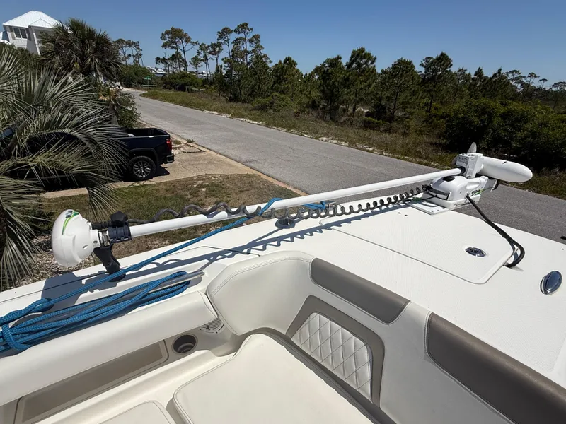 Slide: The Image of 2021 World Cat 280 DC-X boat with dual outboard engines, parked outdoors. - 13