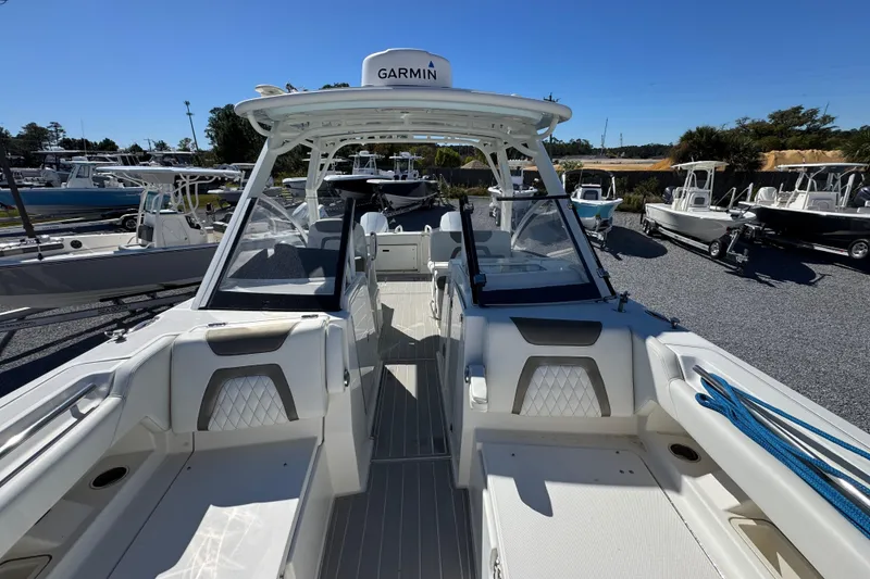 Slide: The Image of 2021 World Cat 280 DC-X boat with Garmin equipment, docked among other boats. - 20