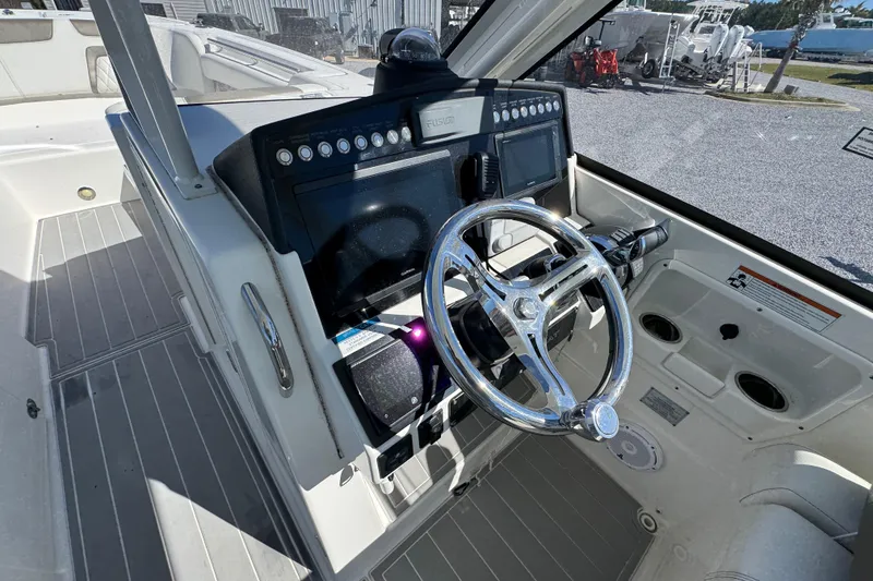 Slide: The Image of Cockpit of 2021 World Cat 280 DC-X boat with modern steering and controls. - 23