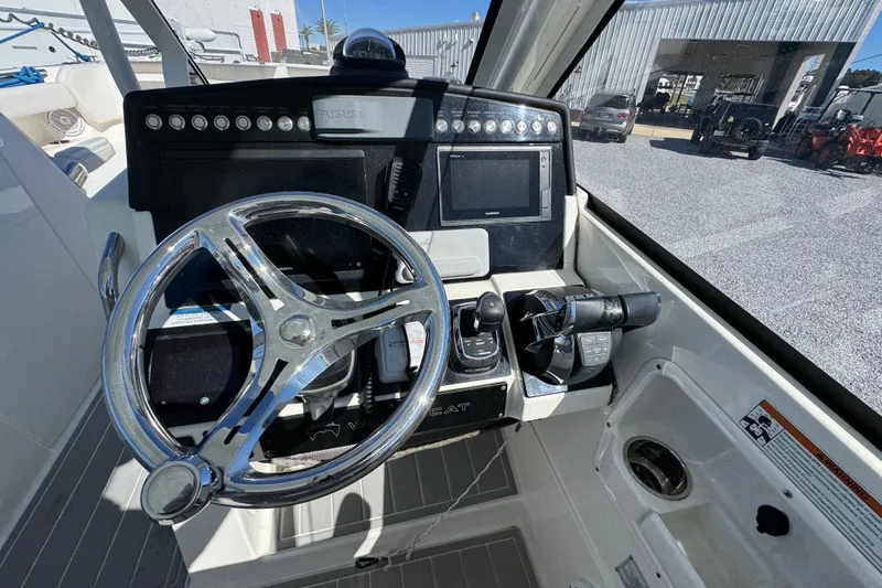 Slide: The Image of Cockpit of 2021 World Cat 280 DC-X boat with steering wheel and control panel. - 24
