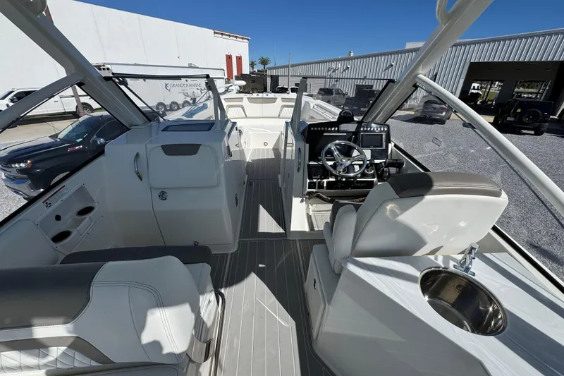 Slide: The Image of Interior view of 2021 World Cat 280 DC-X boat, featuring helm and seating area. - 26