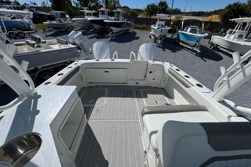 Slide: The Image of 2021 World Cat 280 DC-X boat interior with seating and storage, surrounded by other boats. - 29
