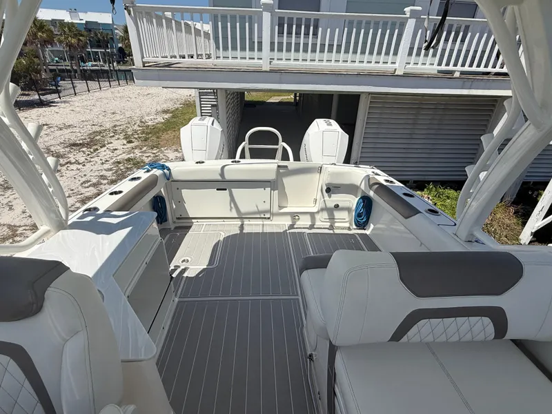 Slide: The Image of 2021 World Cat 280 DC-X boat on trailer under clear blue sky. - 3