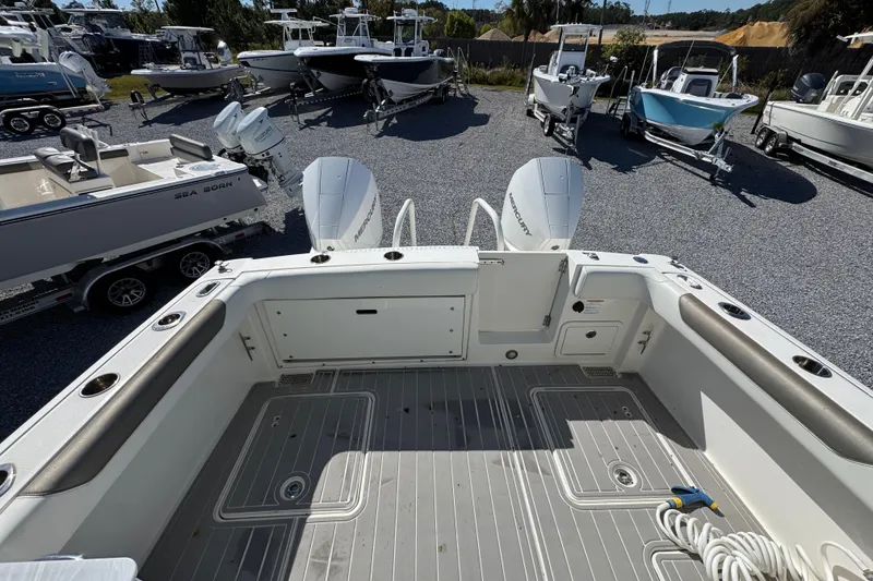 Slide: The Image of 2021 World Cat 280 DC-X boat interior with twin Mercury engines, surrounded by other boats. - 31