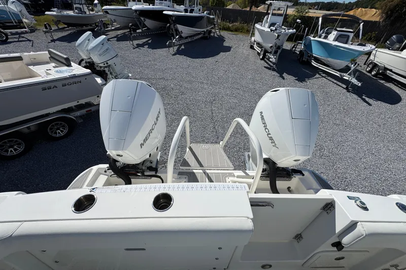 Slide: The Image of 2021 World Cat 280 DC-X boat with dual Mercury outboard engines in a marina. - 32