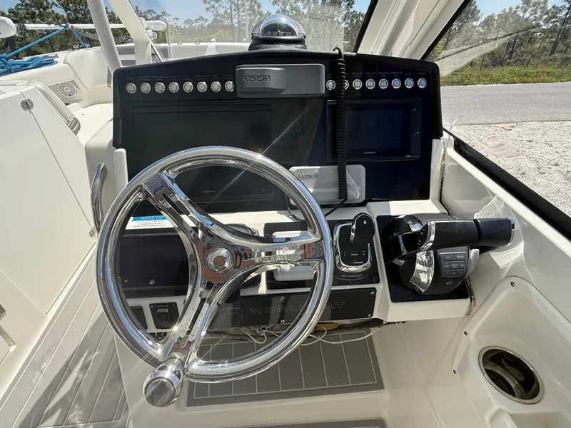 Slide: The Image of 2021 World Cat 280 DC-X boat on trailer under clear blue sky. - 7