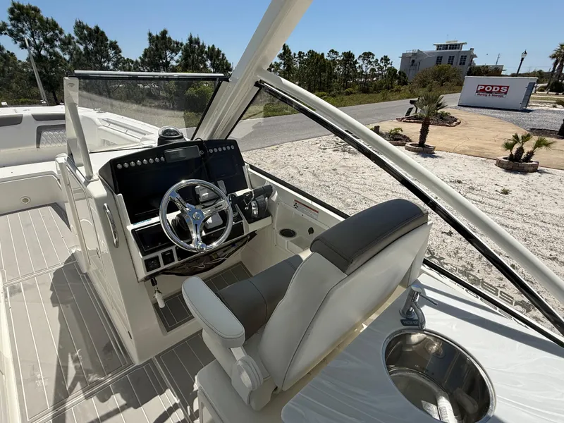 Slide: The Image of 2021 World Cat 280 DC-X boat on trailer under clear blue sky. - 8