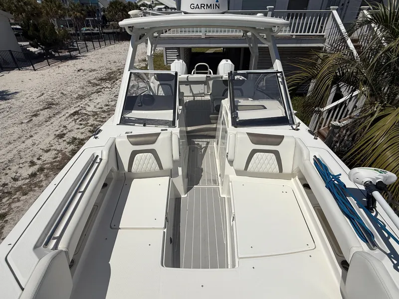 Slide: The Image of 2021 World Cat 280 DC-X boat on trailer under clear blue sky. - 9