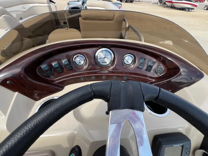 Slide: The Image of Dashboard of a 2012 Bennington 24 SL boat with gauges and controls. - 14