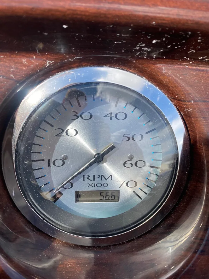 Slide: The Image of Close-up of a 2012 Bennington 24 SL RPM gauge showing 566 RPM. - 15