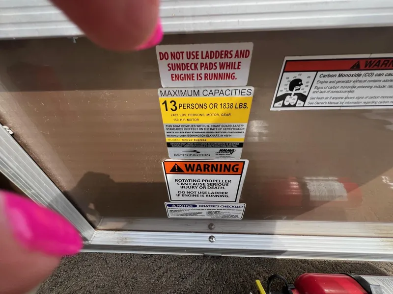 Slide: The Image of Warning labels on a 2012 Bennington 24 SL boat, indicating capacity and safety instructions. - 17