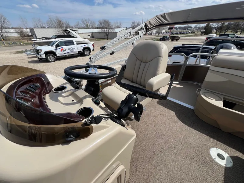 Slide: The Image of 2012 Bennington 24 SL boat interior with steering wheel and captain's chair. - 19