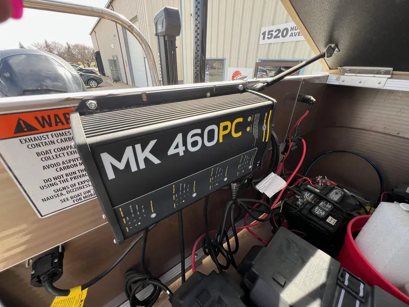 Slide: The Image of MK 460PC charger installed on a 2012 Bennington 24 SL boat, with visible wiring and warning labels. - 22
