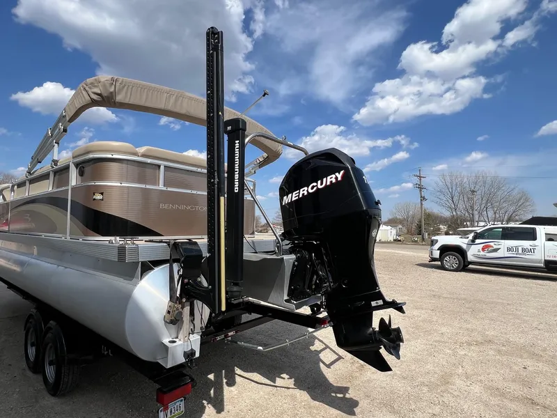 Slide: The Image of 2012 Bennington 24 SL pontoon boat with Mercury outboard motor under a clear blue sky. - 3