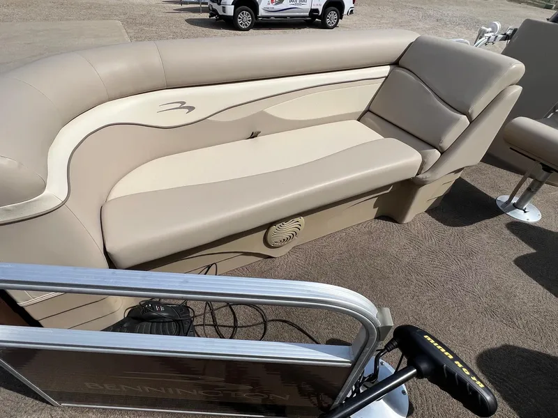 Slide: The Image of 2012 Bennington 24 SL pontoon boat with beige seating and carpeted deck. - 6