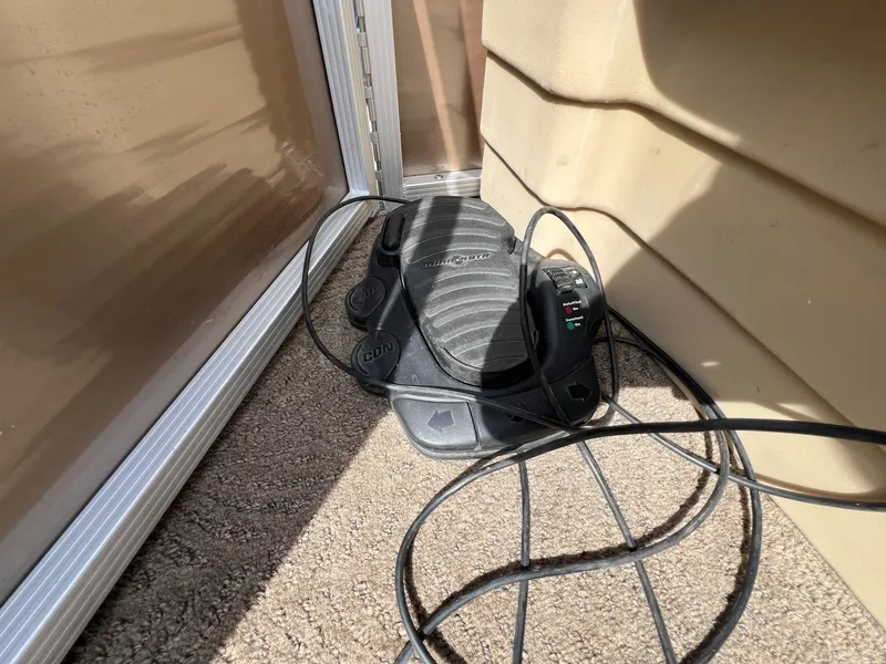 Slide: The Image of Foot pedal control on a 2012 Bennington 24 SL boat, with cables on carpeted floor. - 9