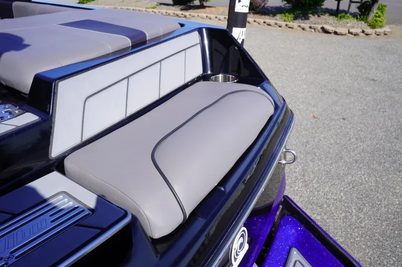 Slide: The Image of 2022 Malibu Wakesetter 23 LSV boat interior with gray seating and cup holder. - 16