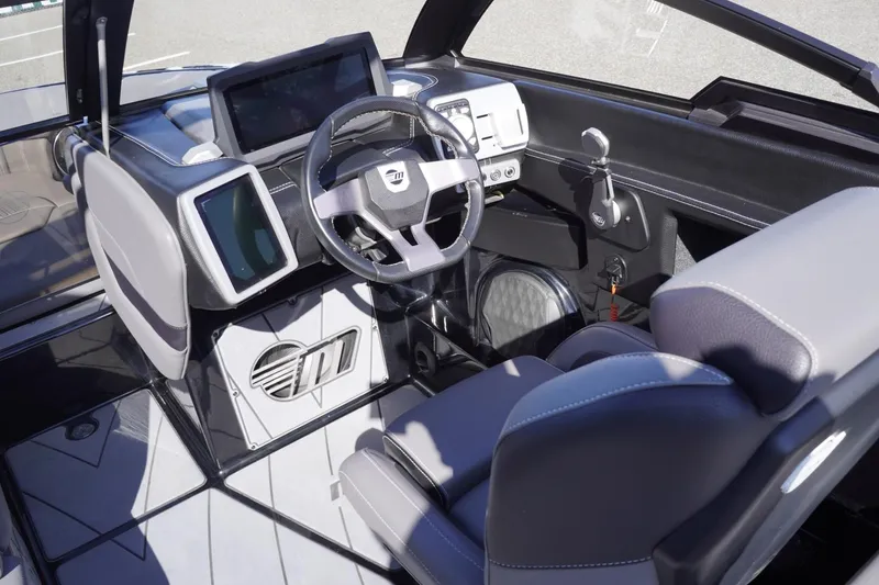 Slide: The Image of 2022 Malibu Wakesetter 23 LSV interior with modern dashboard and steering wheel. - 22