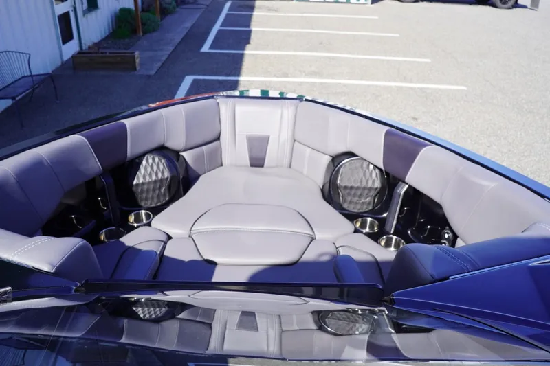 Slide: The Image of 2022 Malibu Wakesetter 23 LSV boat interior with plush seating and cup holders. - 24