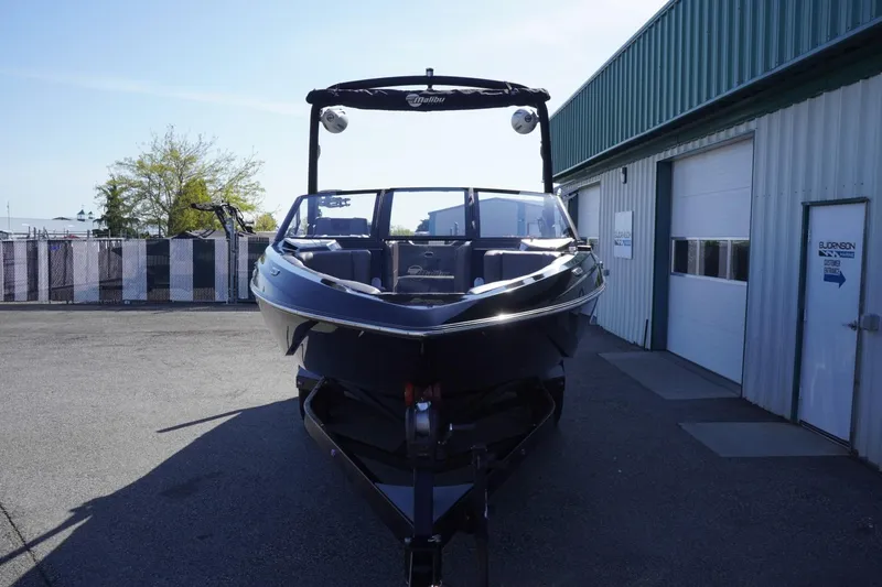 Slide: The Image of 2022 Malibu Wakesetter 23 LSV boat parked outside a warehouse. - 3