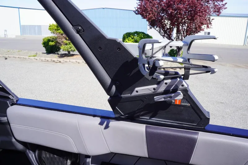 Slide: The Image of 2022 Malibu Wakesetter 23 LSV interior detail with wakeboard rack, outdoor setting. - 42