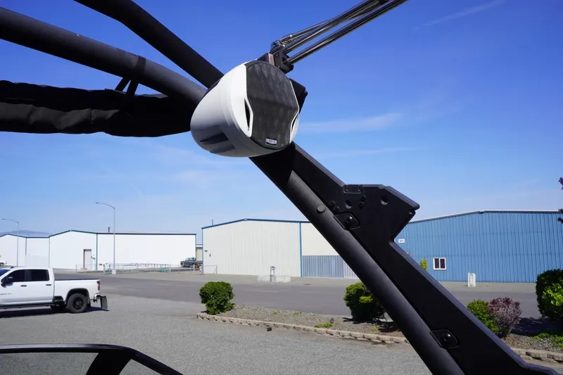 Slide: The Image of 2022 Malibu Wakesetter 23 LSV boat speaker and tower against industrial backdrop. - 43