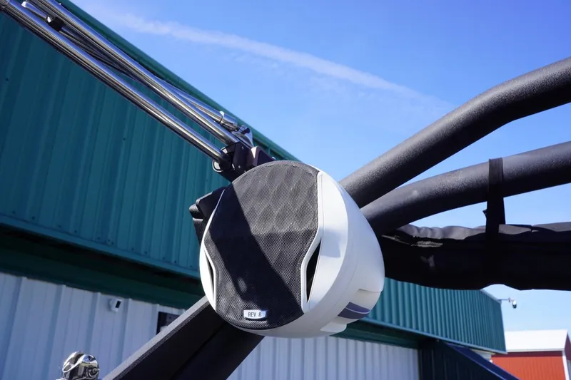 Slide: The Image of 2022 Malibu Wakesetter 23 LSV boat speaker against blue sky and building background. - 47