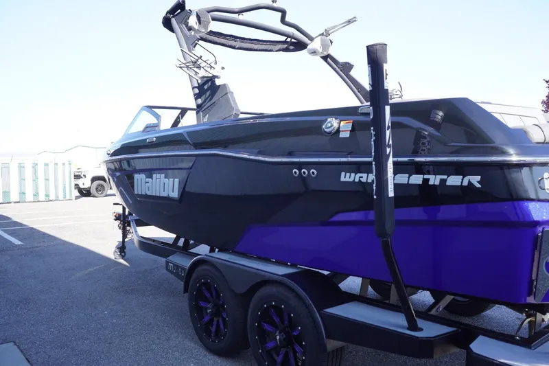 Slide: The Image of 2022 Malibu Wakesetter 23 LSV boat with black and purple design on trailer. - 6