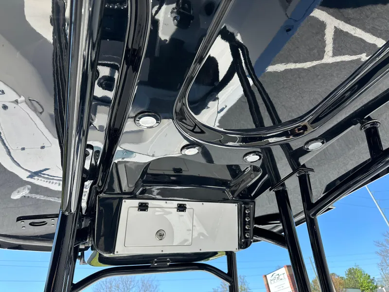 Slide: The Image of 2022 Sea Pro 248 DLX boat's sleek black T-top with integrated lighting and storage. - 11