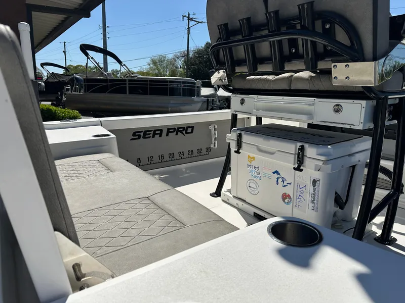 Slide: The Image of 2022 Sea Pro 248 DLX boat interior with seating and storage features. - 15