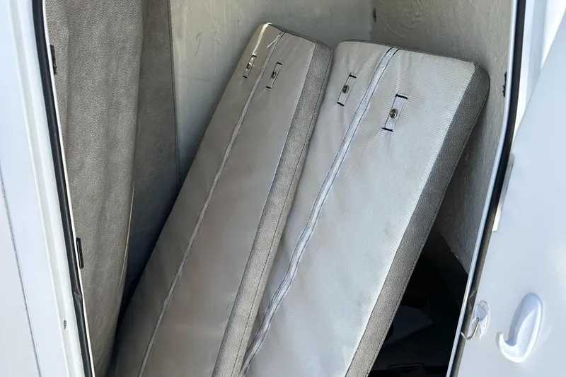 Slide: The Image of 2022 Sea Pro 248 DLX boat cushions stored in a compartment. - 17