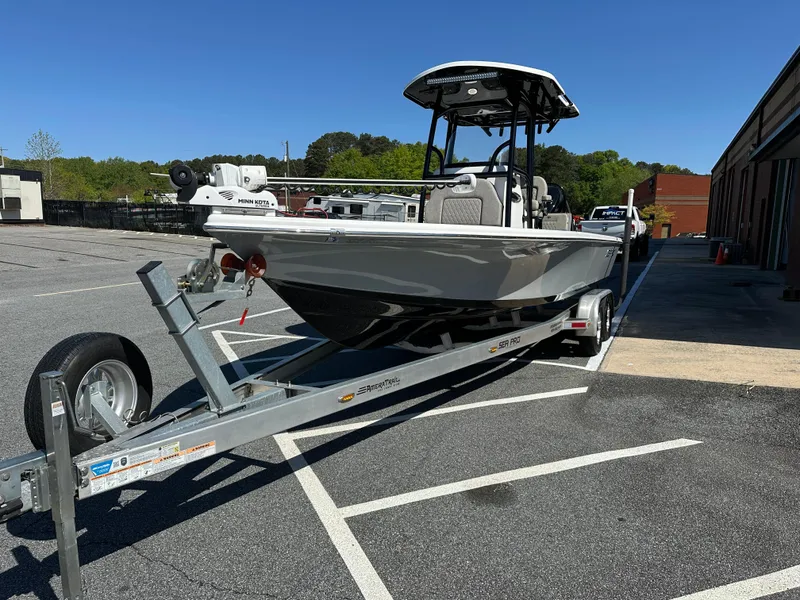 Slide: The Image of 2022 Sea Pro 248 DLX boat on trailer in parking lot, sunny day. - 4